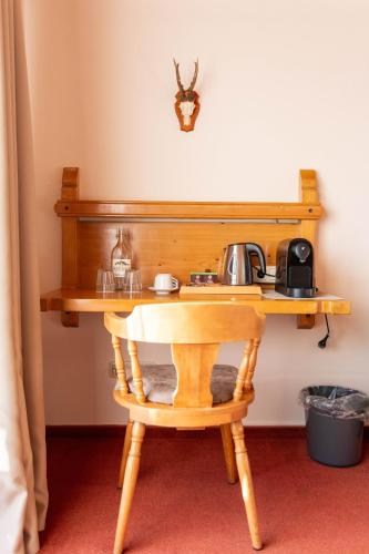 a wooden table with a tea kettle on it at Gasthaus-Pension Seeklause in Ramsau