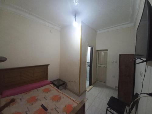 an empty room with a bed and a hallway at Mondy Pyramids Hotel in Cairo