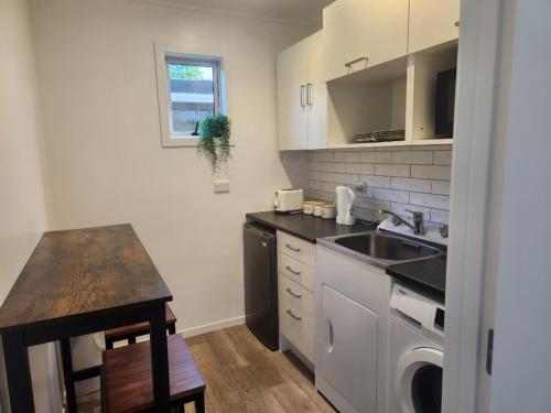 a small kitchen with a sink and a counter at Guest House on Guthrie in Havelock North