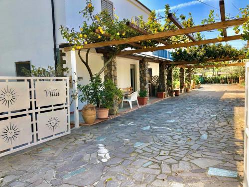 Villa Arco في بالينورو: شارع مرصوف بالحصى مع بريغولا بالنباتات