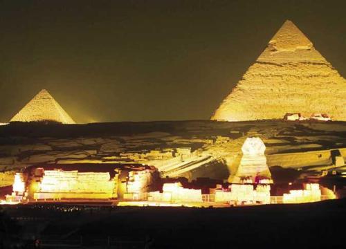 a view of the pyramids of giza at night at Mondy Pyramids Hotel in Cairo