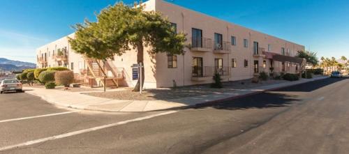 a large white building on the side of a street at 1st Floor Condo in the Desert w/ Pool, Spa & BBQ in Lake Havasu City