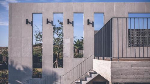 a building with a staircase in front of it at Jeju Private unit for family or group in Jeju