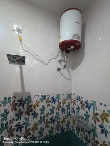 a lamp on the corner of a room with a toilet at Skylight Residency Yercaud in Yercaud