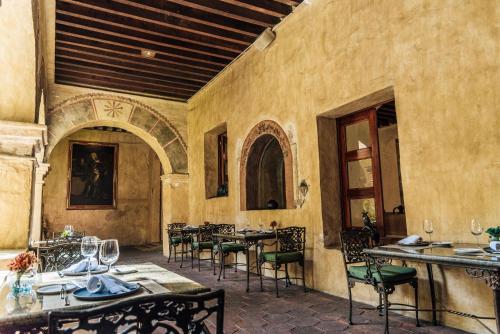 a dining room with tables and chairs in a building at Quinta Real Oaxaca in Oaxaca City