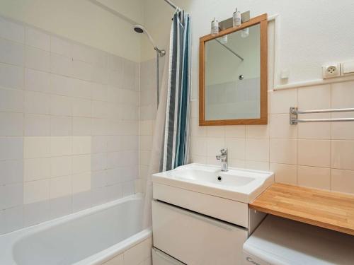 a bathroom with a sink and a tub and a mirror at Appartement au calme à 300 m des plages, 2 chambres, parking, jardin, Guéthary - FR-1-4-686 in Guéthary
