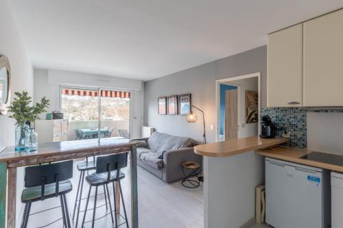 une cuisine et un salon avec un comptoir dans l'établissement Appartement des Tchanquées - Welkeys, à Arcachon