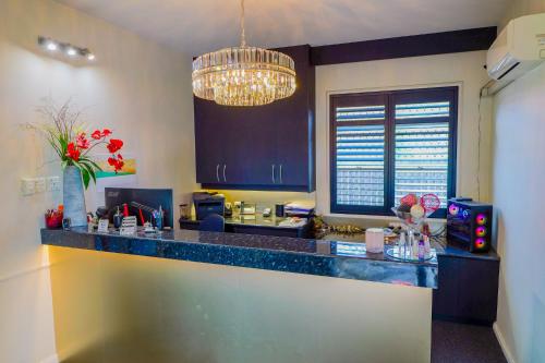 cocina con encimera y lámpara de araña en Abbotsleigh Motor Inn, en Armidale