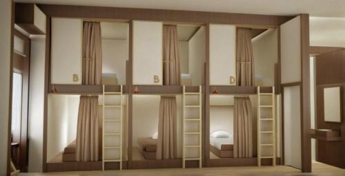 a room with two bunk beds and a bedroom at D'Pavilion Malioboro in Sentool