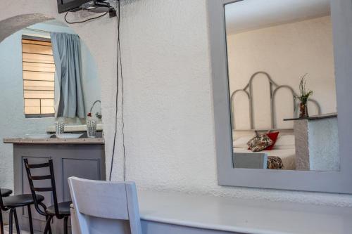a mirror on the wall of a room with a bed at Suite/ terraza en la glorieta chapalita in Guadalajara