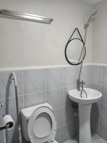 a bathroom with a toilet and a sink at "Zen Spot" Saekyung Condo Unit in Lapu-Lapu City in Lapu Lapu City