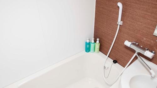 a bathroom with a sink and a faucet at Hotel Route Inn Grand Wakayama Eki Higashiguchi in Wakayama