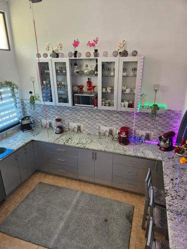 a kitchen with white cabinets and a counter top at Very cozy beautifully designed loft apartment in Coco