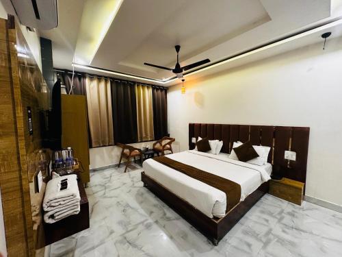 a bedroom with a large bed and a table at Hotel Fusion in Kurukshetra