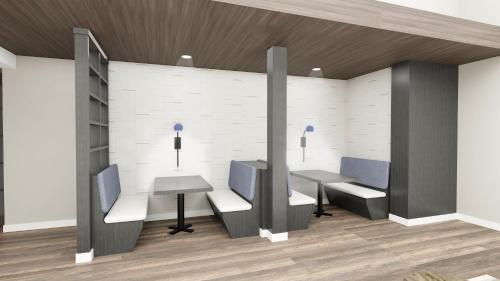 an office with two desks and chairs and a wall at Clarion Pointe Rhinelander Downtown in Rhinelander