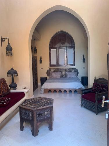 a bedroom with a large bed and two chairs at Nubia Gouna in Hurghada