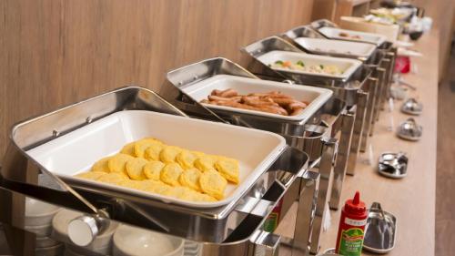 a row of trays of food on a buffet line at Hotel Route Inn Grand Kainan Ekimae in Kainan