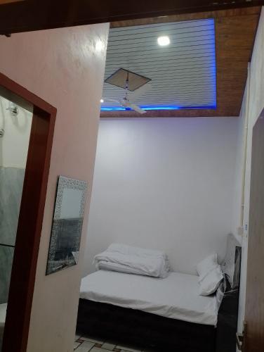 a small room with a bed and a window at CHOICE HOTEL AND RESTAURANT in Hanumāngarh