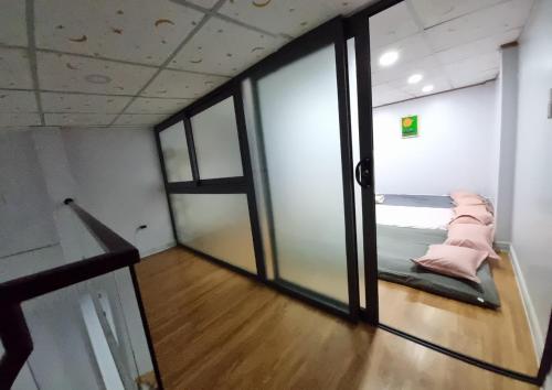 an empty room with a bed and a glass door at Homestay nguyên căn Ngọc Vân in Ho Chi Minh City