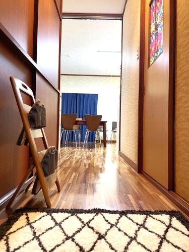 a living room with a chair and a table at Nikko World Heritage STAY【日光山内】一棟丸貸しの宿 in Nikko