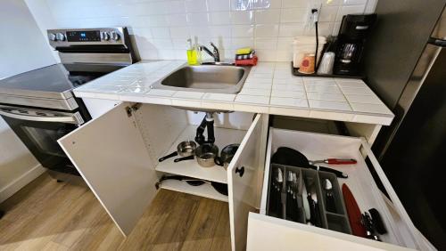 a small kitchen with a sink and a counter at Cloud 9 Inn in Whitecourt