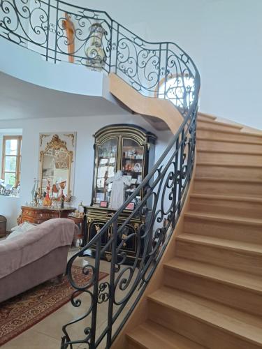 a spiral staircase in a living room at chez céline in Sens-de-Bretagne