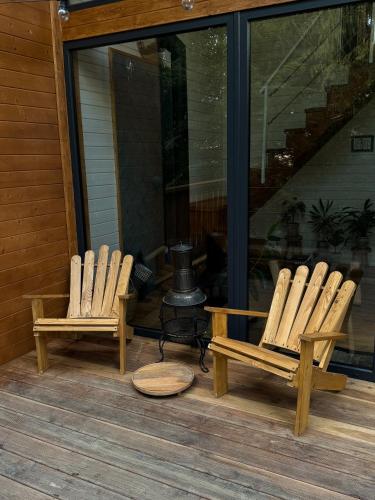 two rocking chairs on a porch with a fountain at Chili Shale in Yablunytsya