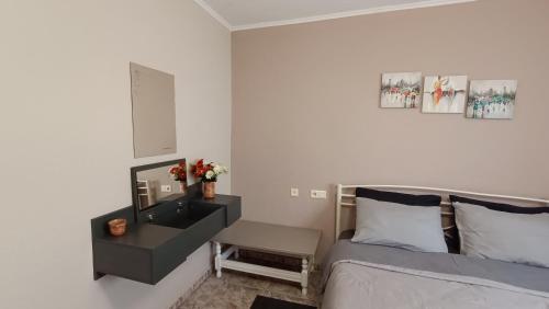 a bedroom with a bed and a dresser with a mirror at Apartments to nature A in Ámmos