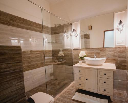 a bathroom with a sink and a shower at Silver Leaf Apartments in Amritsar