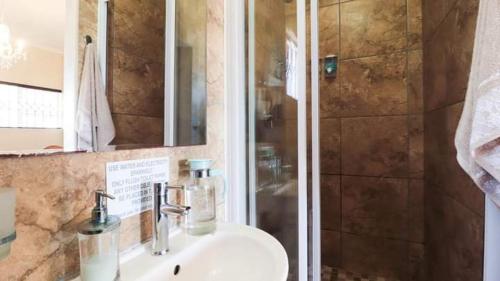 a bathroom with a sink and a shower at 54 Asteria Ave, Larnaco Estate in Kingsburgh