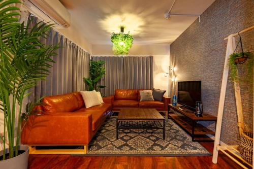 a living room with a couch and a table at Premier suite MEGURO Tokyo in Tokyo