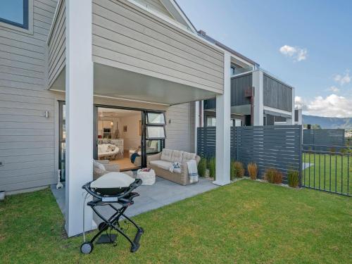 a barbecue grill on a patio next to a house at Tairua Marina Villa in Tairua