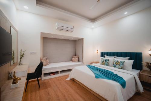 a bedroom with a large bed and a bench at Silver Leaf Apartments in Amritsar