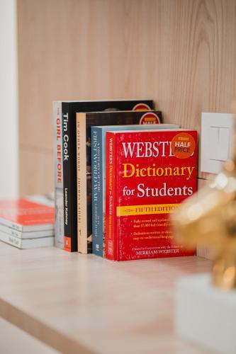 a group of books sitting on a shelf at Silver Leaf Apartments in Amritsar