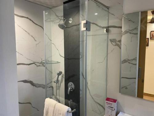 a shower with a glass door in a bathroom at The Grand Anukampa in Jaipur