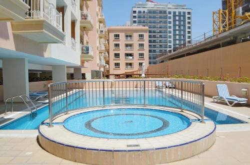 a swimming pool in the middle of a building at A chilled place JVC in Dubai
