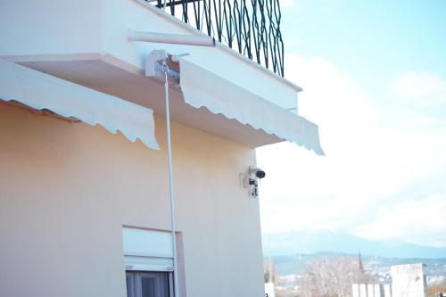 a white building with a staircase on it at apartment to nature B in Ámmos