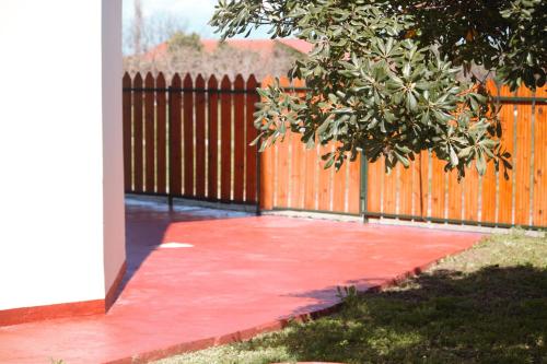 a red sidewalk next to a wooden fence at apartment to nature B in Ámmos