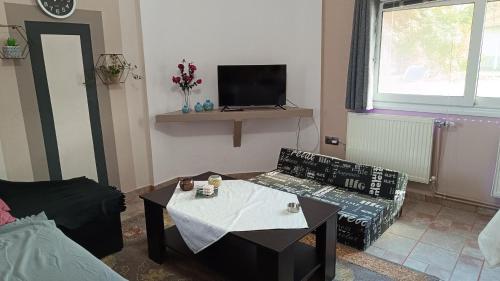 a living room with a couch and a table at apartment to nature B in Ámmos