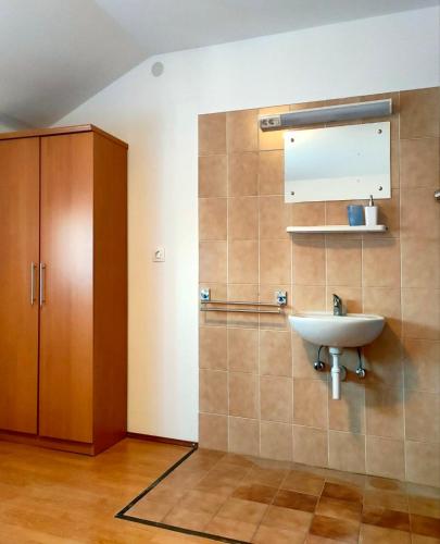 a bathroom with a sink and a cabinet at Skajla Apartments in Medulin