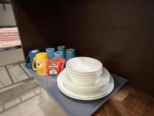 a stack of white plates sitting on a table at CEOZ1 Duplex 1BR Suite #Disneys HS #USM #SPICE in Bayan Lepas