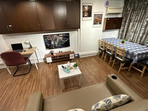 a living room with a couch and a dining room table at CEOZ1 Duplex 1BR Suite #Disneys HS #USM #SPICE in Bayan Lepas