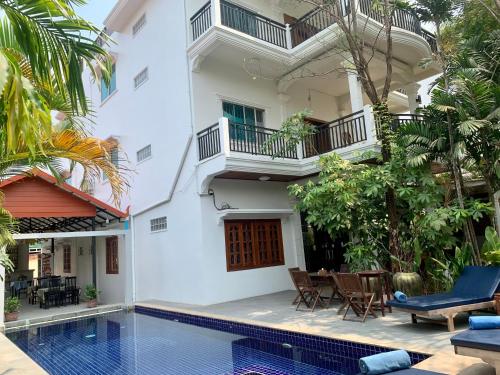 a villa with a swimming pool and a house at The One by Nika in Siem Reap