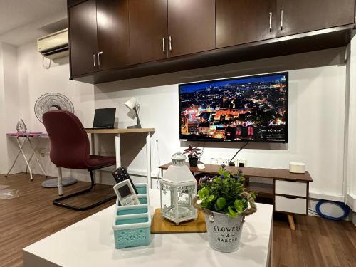 a living room with a large tv on the wall at CEOZ2 6-7Pax Duplex 2BR Suite #Airport #USM #SPICE #Pantai in Bayan Lepas
