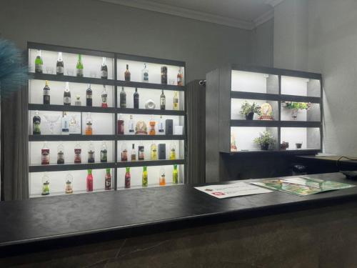 a counter with a display of bottles of alcohol at Merdan Hotel in Zaozërnyy