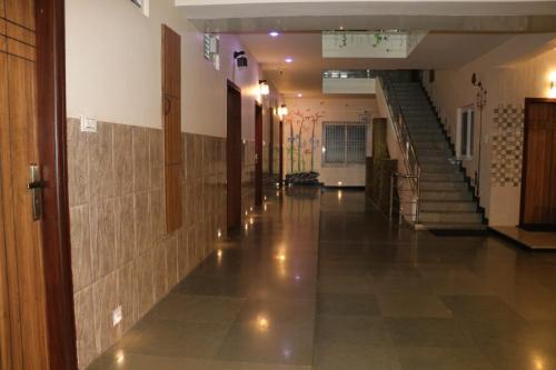 an empty hallway of a building with a staircase at Hotel Lemon Stay in Yercaud