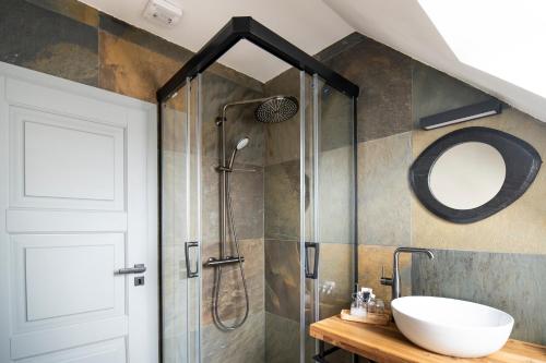 a bathroom with a shower with a sink and a mirror at Dům u města Milána - sedm dveří, sedm světů in Lanškroun