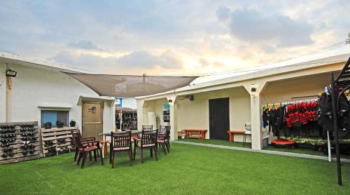 a patio with chairs and a table with a tent at sea monkey diving homestay in Green Island
