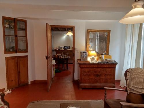 a living room with a table and a hallway at Le Mas Palegry Chambres d'hôtes Perpignan in Perpignan