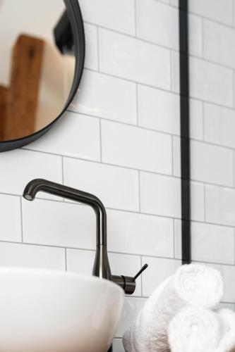 a bathroom with a sink and a mirror at Dům u města Milána - sedm dveří, sedm světů in Lanškroun